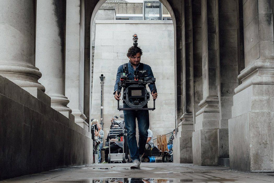Man-holding-Gimbal-Maxima-while-walking