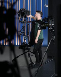 cameras on a filmset getting prepared from a man
