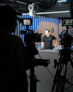 Man filming Alex Voigt on set